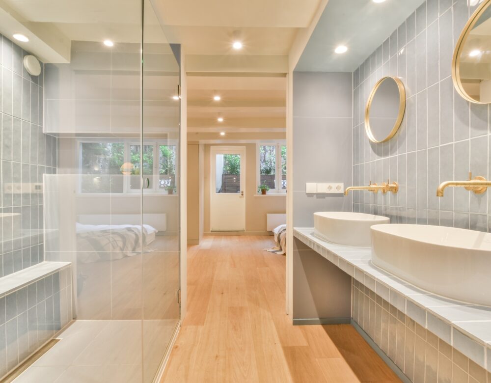 Sink with tap and liquid soap under mirror in contemporary restroom at home